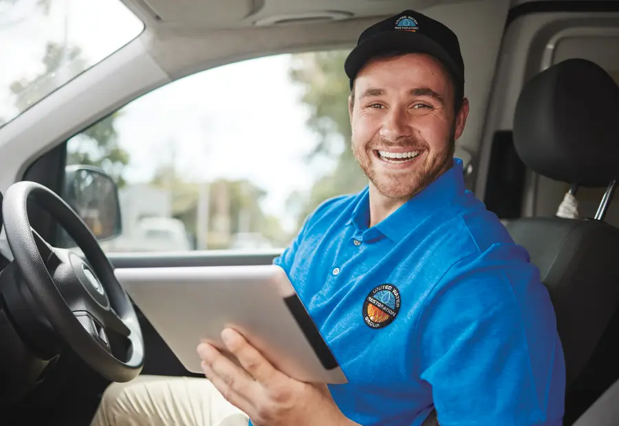 A technician documenting a job on a tablet from the van